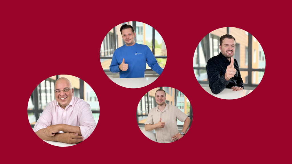Vier Personen lächeln freundlich in die Kamera.