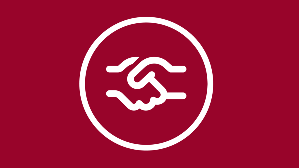 Ein weißes Symbol von zwei schüttelnden Händen - alles auf roter Fläche