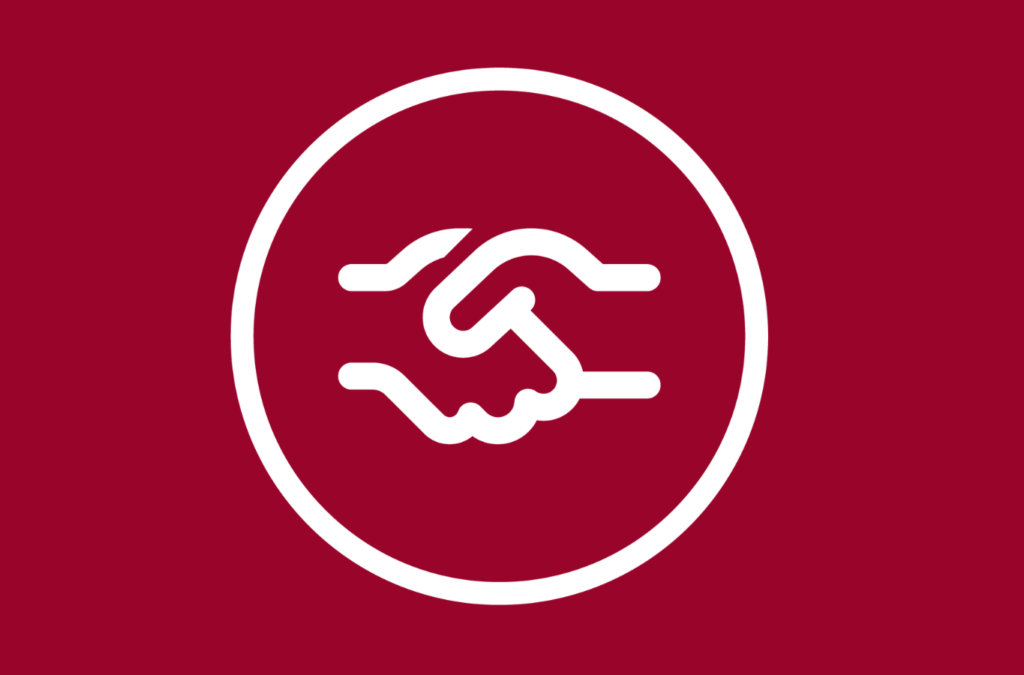 Ein weißes Symbol von zwei schüttelnden Händen - alles auf roter Fläche